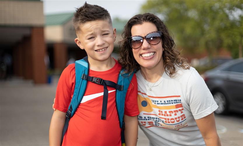 A mother and son smile